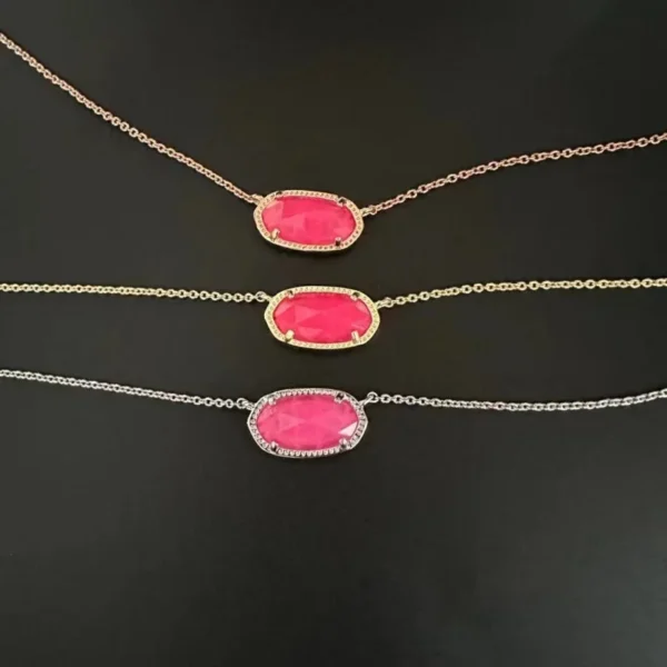 Three pink stone necklaces on black background.