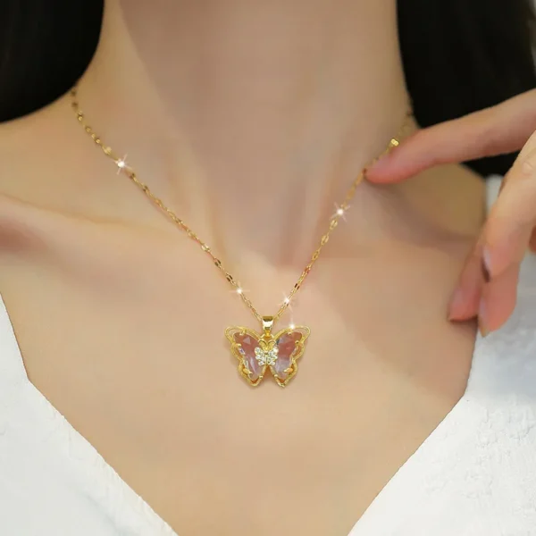 Gold chain necklace with butterfly pendant.