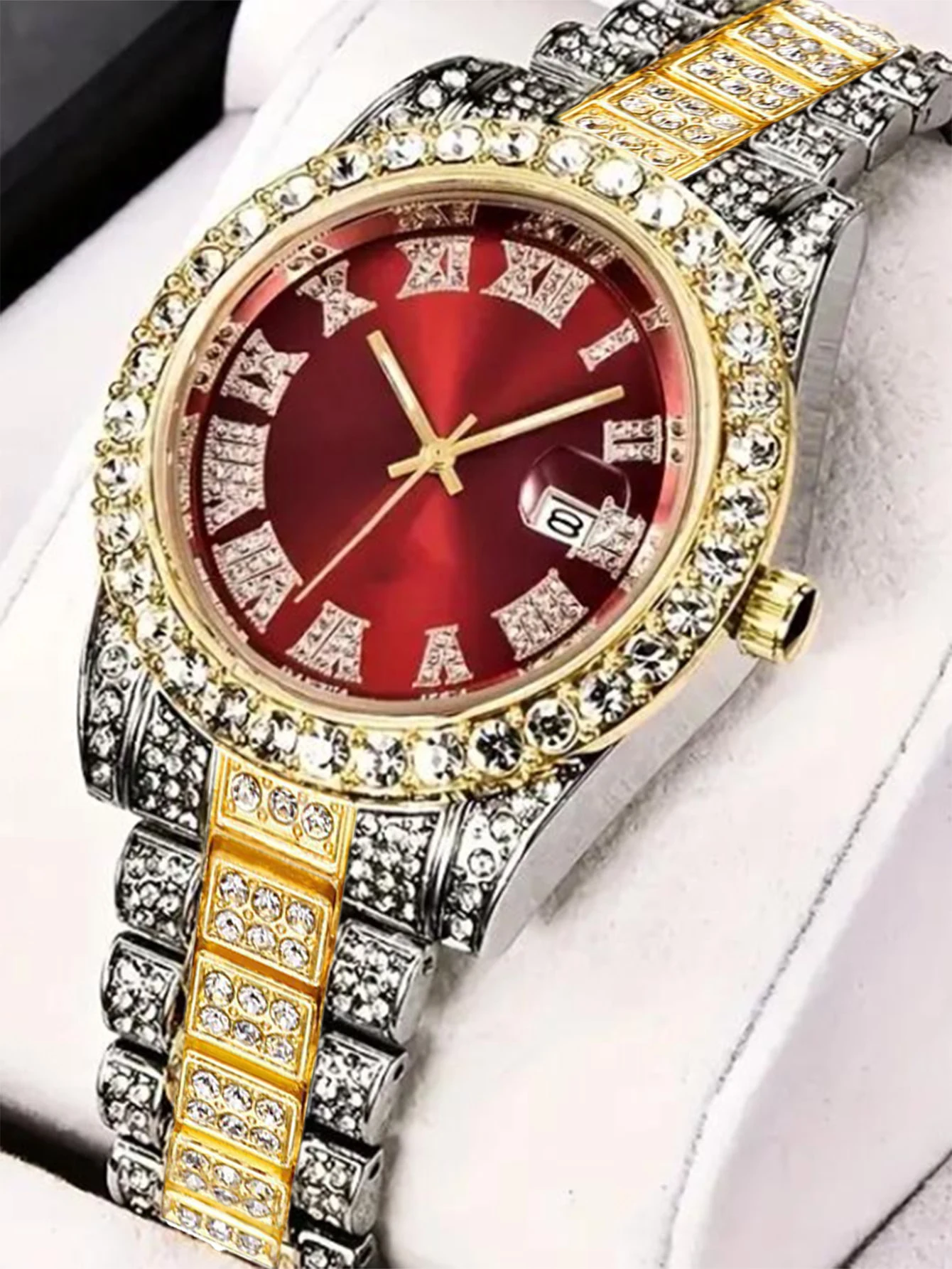 Diamond encrusted watch with red face.