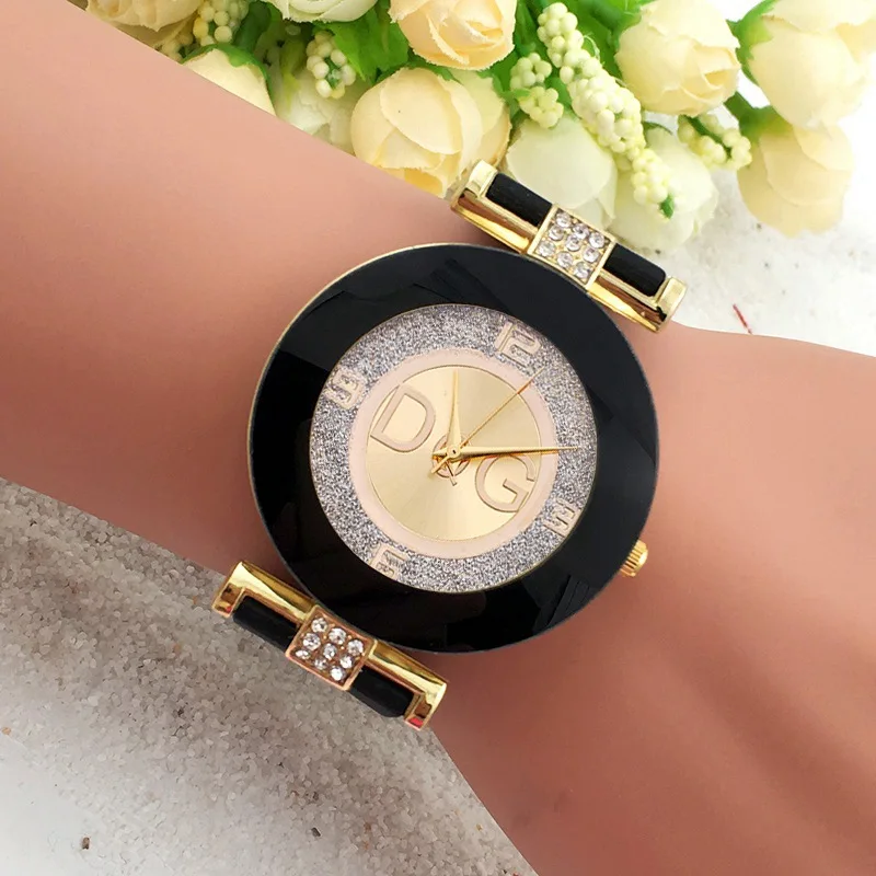 Gold and black wristwatch with DG logo.