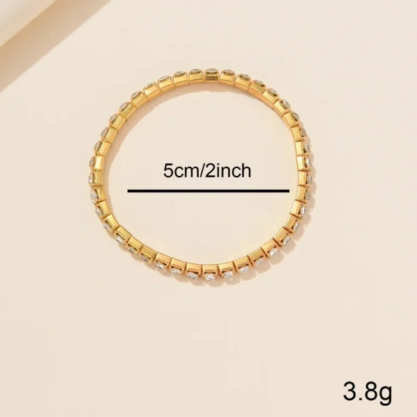 Gold bracelet with clear rhinestones.