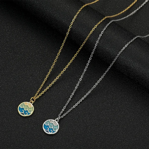 Gold and silver necklaces with wave pendants.