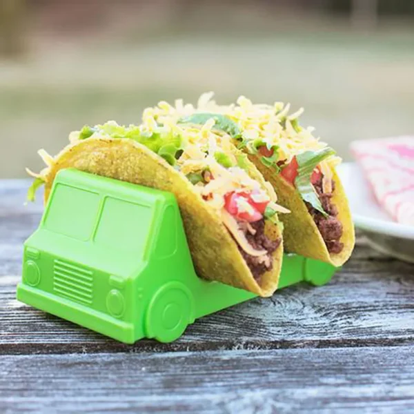 Two tacos in a green truck holder.