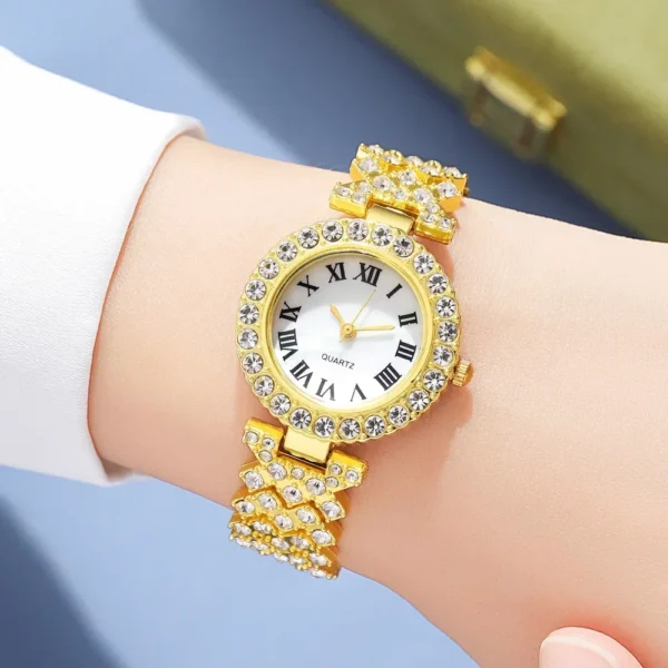 Gold jeweled watch on a wrist.