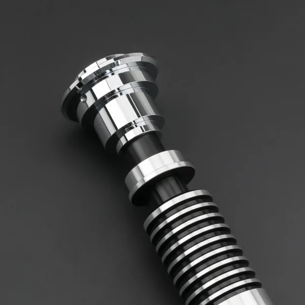 Close-up of a silver lightsaber hilt.