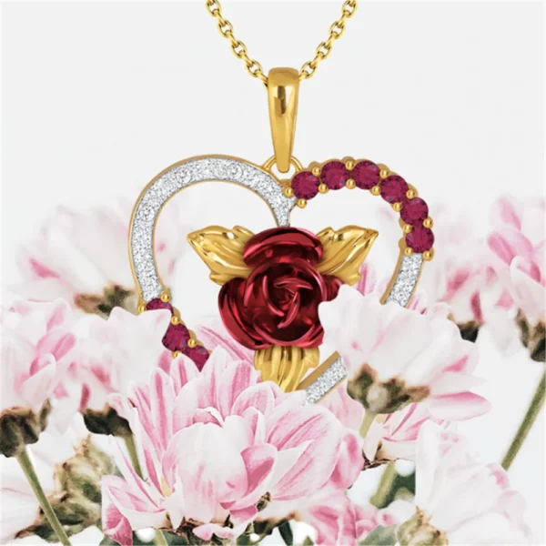 Gold heart pendant with red rose and gems.